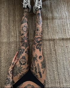 a woman with tattoos on her legs and arms