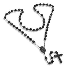 a rosary with a cross on it and a small black bead necklace in the shape of a crucifix