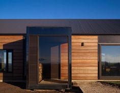 a wooden building with glass doors on the outside and wood sidings on the inside