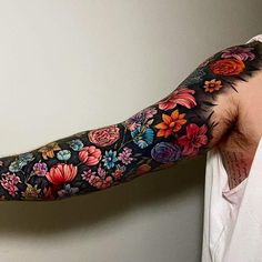 a man's arm with flowers painted on it