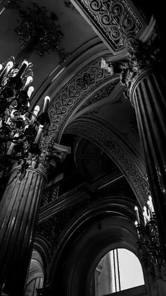 black and white photograph of an ornate building with chandelier hanging from the ceiling