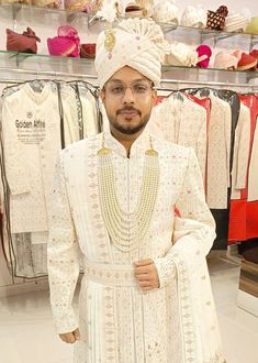 a man standing in front of some clothes