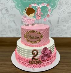 a pink and white two tiered birthday cake with a ballerina on top that says 2nd