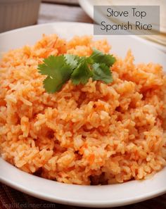 mexican rice on a white plate with cilantro