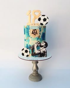 a blue cake with soccer themed decorations on it