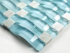 a blue and white checkerboard design glass tile on a wall or table top