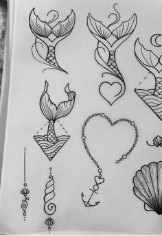 some tattoos are drawn on paper and have been placed in the shape of mermaids