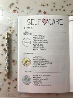 an open notebook with the words self care written on it next to a pen and stars