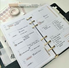 an open planner book sitting on top of a table