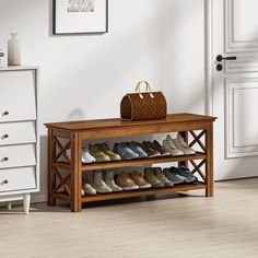 a wooden shoe rack with several pairs of shoes on it next to a white dresser