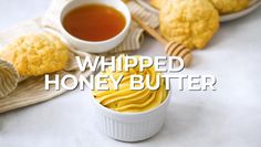 whipped honey butter in a small white bowl next to some cookies and cup of tea