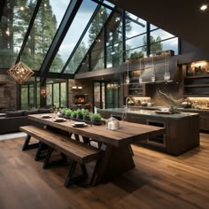 an open kitchen and dining area with wood flooring, large windows, wooden benches, and glass walls