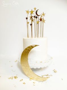 a white cake with gold stars and a crescent on top