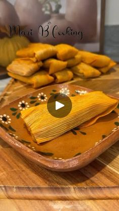 corn on the cob is sitting on a cutting board next to other food items