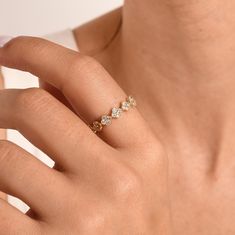 a woman's hand with a diamond ring on it