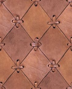 a close up view of a brown leather wallpaper with knots and rivets