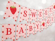 a baby shower banner with strawberries on it