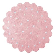 a pink rug with white polka dots on the top and blue spots on the bottom