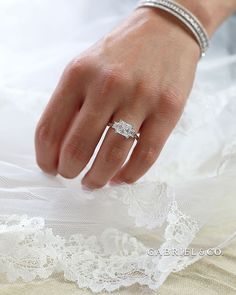 a close up of a person's hand with a wedding ring on their finger