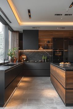 a modern kitchen with black cabinets and marble counter tops