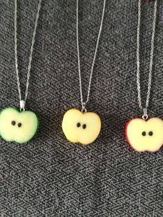 (1505)  Apple Slice Necklaces and Earrings.  Made with resin, about 1" x 1 1/4" Earrings on stainless steel ear wires Necklaces on 18" stainless steel chain with extender and an apple charm A) Green Apple Slice Necklace w/ Charm and Earrings  B) Yellow Apple Slice Necklace w/ Charm and Earrings  C) Red Apple Slice Necklace w/ Charm and Earrings Apple Core Outfits, Cool Trinkets, Fruits Fashion, Clay Necklace Pendant, Apple Clothes, Apple Jewelry, Quirky Accessories, Apple Necklace, Apple Slice