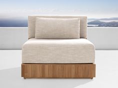 a white couch sitting on top of a wooden frame