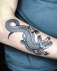 a man with a dragon tattoo on his arm