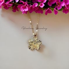 This pendant features a beautiful large Hibiscus flower with cubic zirconia stones. Absolutely stunning and sparkles in the light. The chain measures 21 inches with a 3 inch extender attached for your adjustment. You can easily adjust the necklace to your fitting up to 24 inches in length. The Gold chains are solid and sturdy and very durable. Hibiscus Pendant Measurements: Width: 25mm wide Height: 27mm Luxury Gold Flower Necklace, Luxury Delicate Jewelry With Flower Pendant, Hibiscus Flower Necklace, Hibiscus Jewelry, Gold Flower Jewelry, Hibiscus Necklace, Custom Gold Jewelry, Crystal Jewelry Necklaces, Hawaiian Necklace