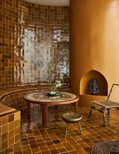 a living room filled with furniture and a fire place next to a wall covered in tiles