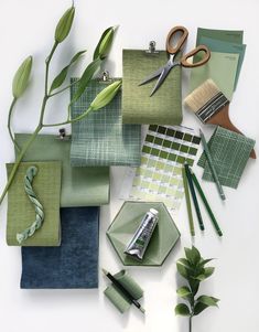 green and blue color scheme with scissors, pencils, papers, paper clips and other items