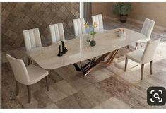 a marble dining table with white chairs and vases on it in a room that has tile flooring