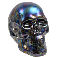 a black and silver skull is shown against a white background in this image, it appears to be made out of iridescent material