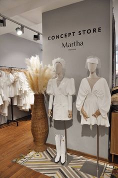 two mannequins dressed in white are on display