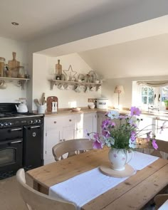 a kitchen with an oven, stove and table set for four in front of it