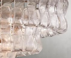 several clear glass vases hanging from a metal rod