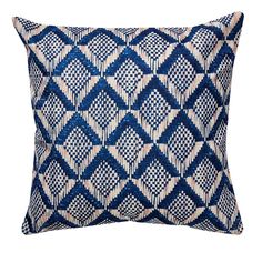 a blue and white pillow on a white background