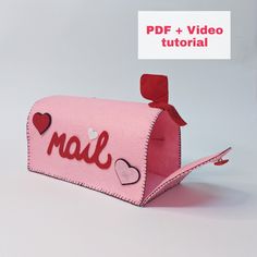 a pink mailbox with hearts and the word mail printed on it