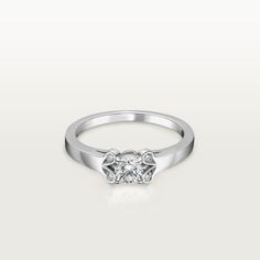 a white gold ring with two diamonds on the top, and one diamond in the middle