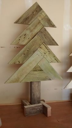 a wooden christmas tree sitting on top of a table