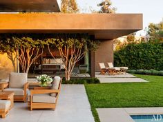 an outdoor living area with couches and chairs