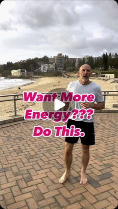 a man standing on top of a brick walkway next to the ocean with words that read, want more energy? do this