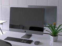 a computer monitor sitting on top of a white desk next to a keyboard and mouse