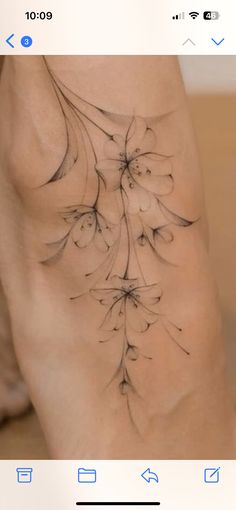 a woman's leg with flowers on it