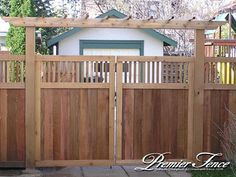 a wooden fence in front of a house