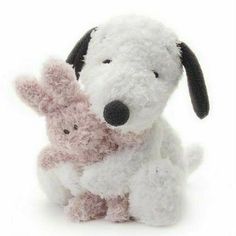 a white stuffed dog holding a pink teddy bear