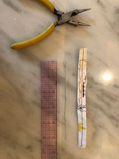 scissors, ruler and tape measure on a marble surface