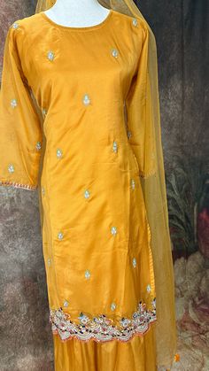 Mustard yellow embroidered kurti with gharah and dupatta Eid Yellow Straight Kurta Lawn Suit, Gold Kurta With Dabka Work For Diwali, Eid Yellow Lawn Suit In Straight Kurta Style, Bollywood Style Gold Kurta With Dabka Work, Yellow Lawn Suit For Eid With Straight Kurta, Yellow Chanderi Unstitched Suit With Dabka, Yellow Dabka Unstitched Chanderi Suit, Gold Chanderi Straight Kurta Lawn Suit, Gold Chanderi Lawn Suit With Chikankari Embroidery