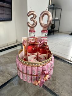 a birthday cake made to look like a basket with bottles and balloons in it that say 30