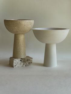 two white bowls sitting next to each other