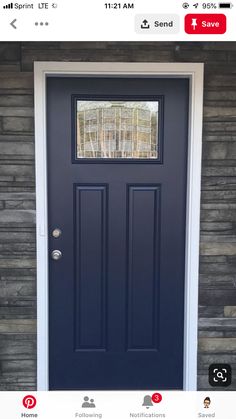 the front door is painted dark blue and has two sidelights on each side, which are